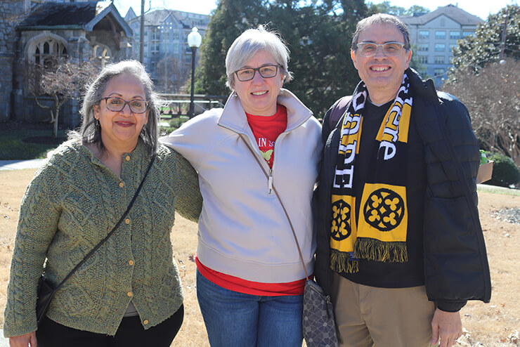 Drs. Shrikande, Schmeichel, and Nardo embrace on the quad during Oglethorpe Day festivities.